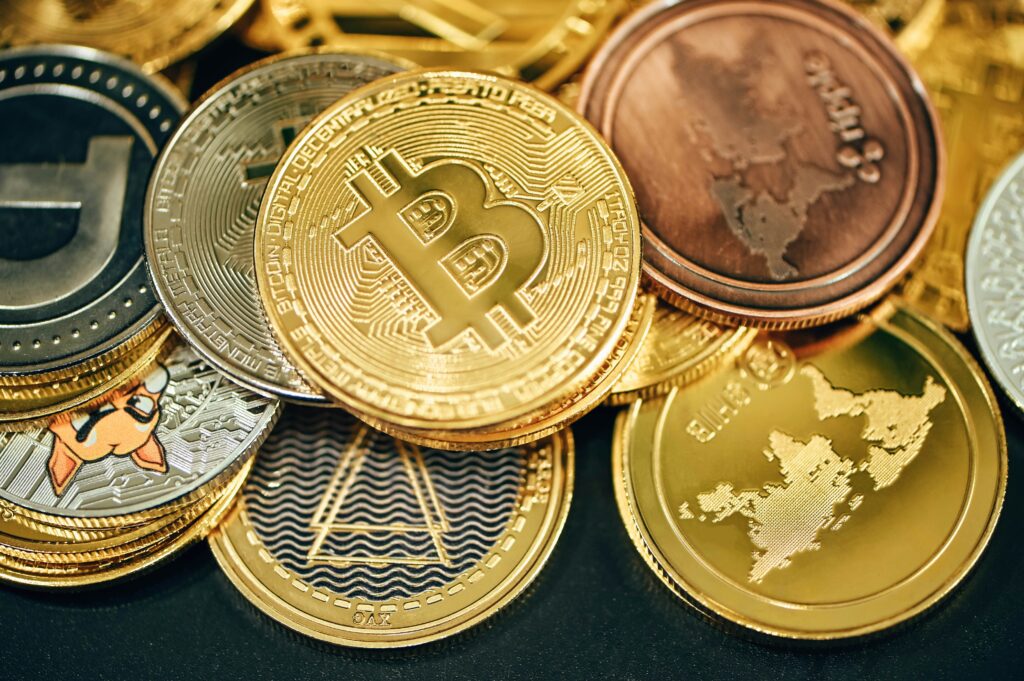 Different cryptocurrencies as gold coins.