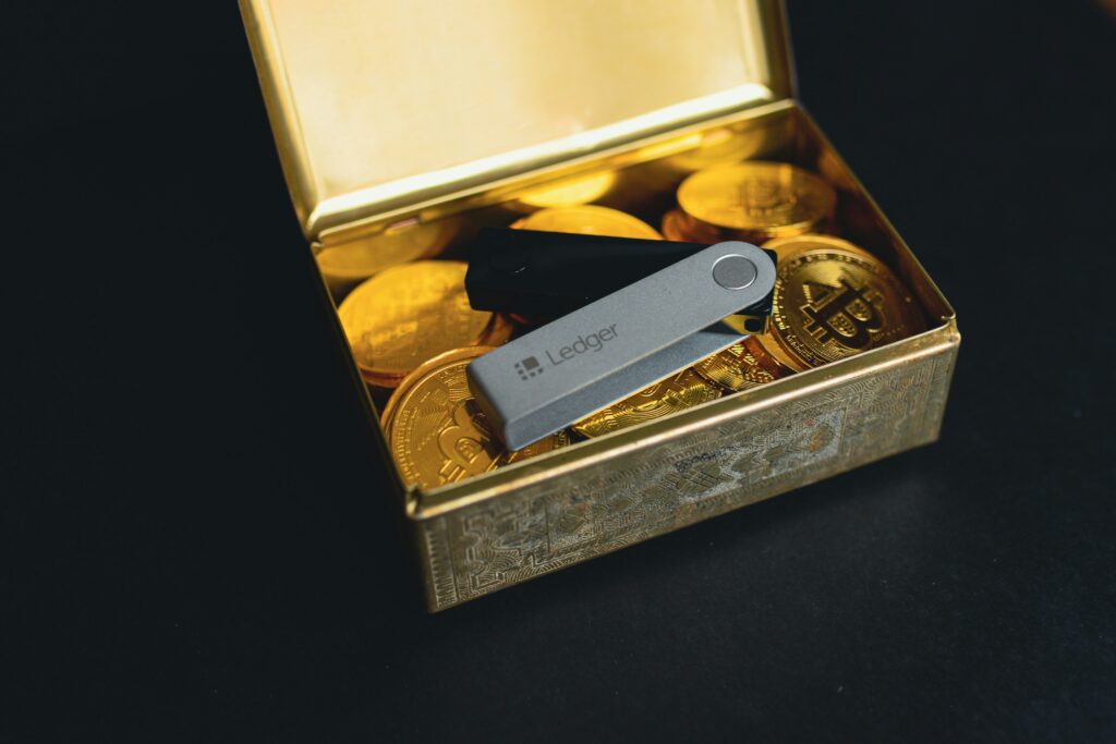 Ledger wallet in tin with golden bitcoins.